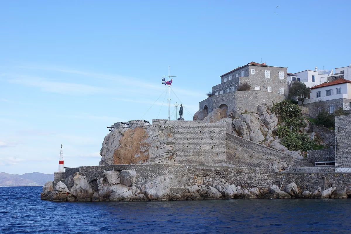 The fortified entrance to Hydra's harbour, with the town rising behind it
