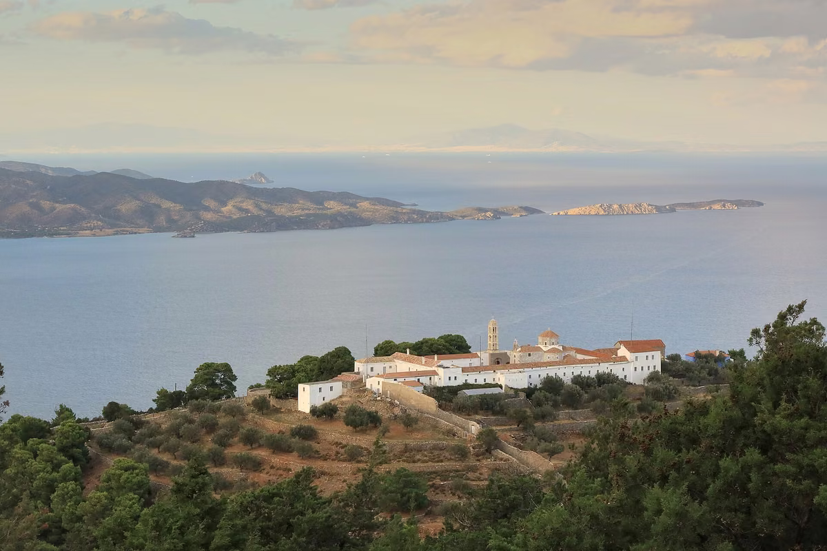 The monastery of Profitis Ilias on a shoulder above the sea, with islands on the horizon