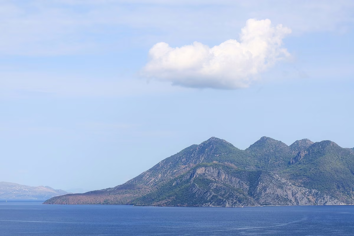 Bare lava domes stacked one behind another on the western side of Methana